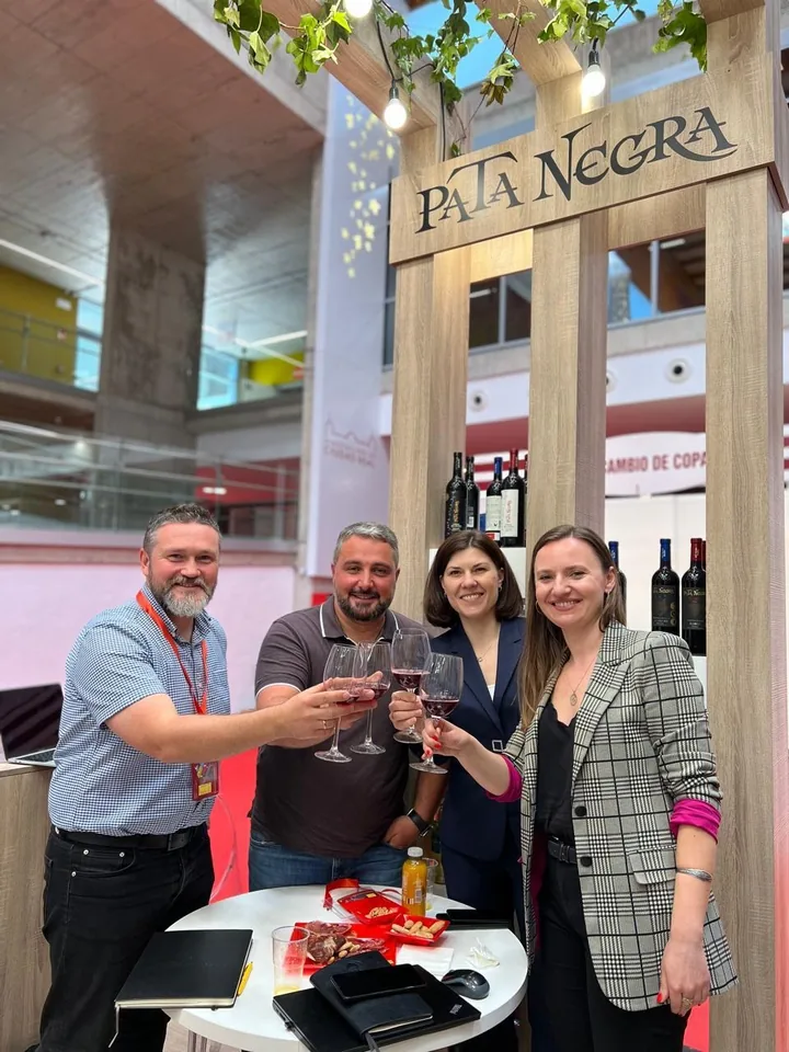 VLC team with partners at a Spanish cured ham stand at a food trade fair