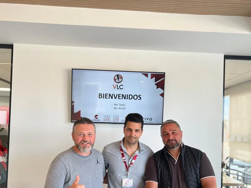 The VLC team at a supplier visit, with a welcome screen for VLC