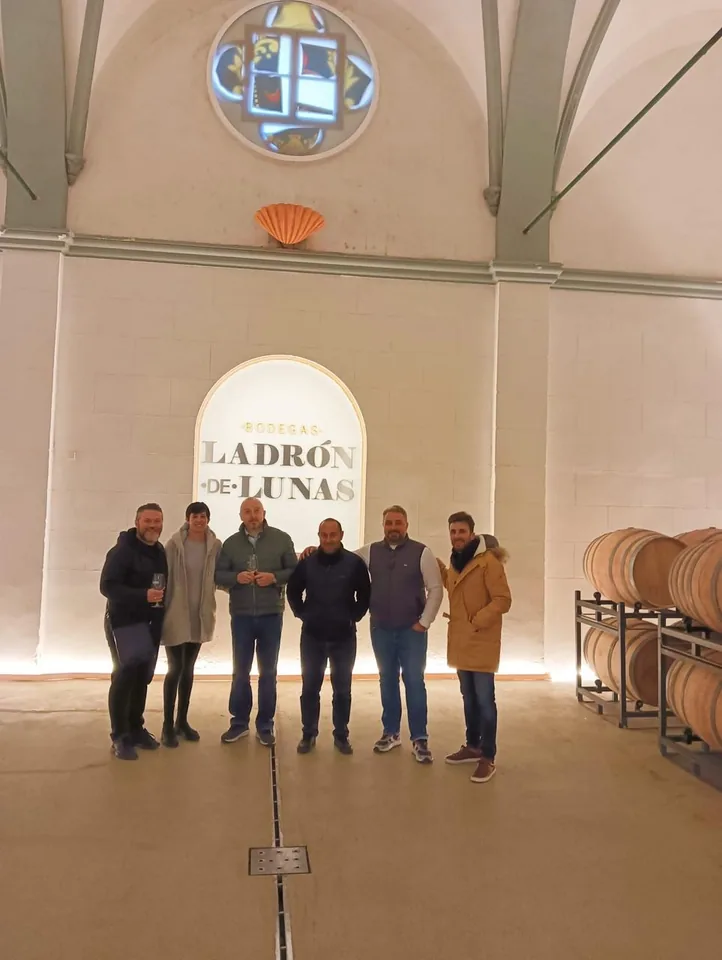 Group standing in the vaulted hall of the Ladron de Lunas winery